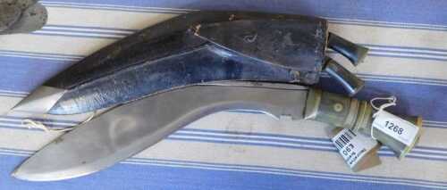 V - A 20thC Kukri with a horn handle, a plain blade, two miniature daggers, and a scabbard with a...