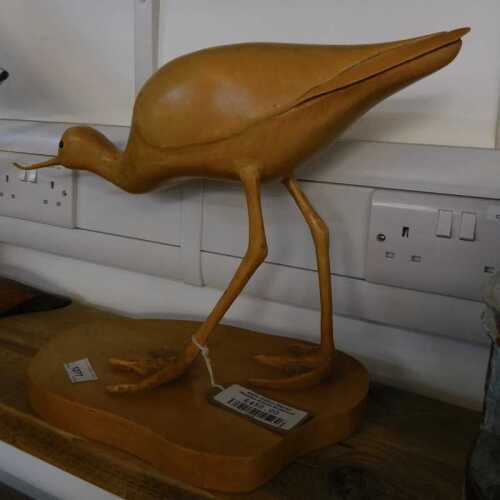 V - An Eddie Hallam sculpture of a wooden avocet, on a plinth base, 35cm high. NB. VAT is payable on...