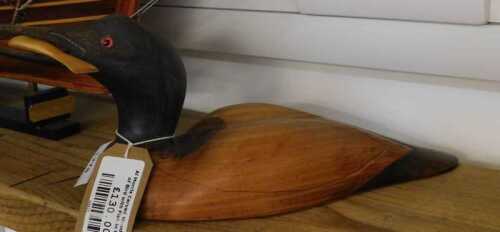V - A Morris Design carved wooden duck model, with fish to the mouth, 27cm wide. NB. VAT is payable...