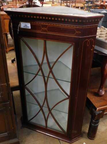 V - An Edwardian mahogany and boxwood strung corner hanging display cabinet, with astragal glazed...
