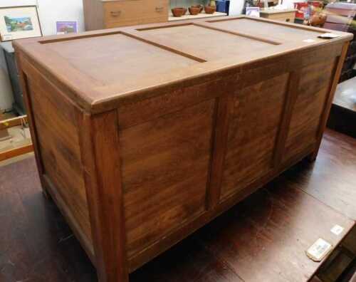 V - A 20thC teak blanket box, with three plain panels, on block stiles, 48cm high, 92cm wide, 46cm...