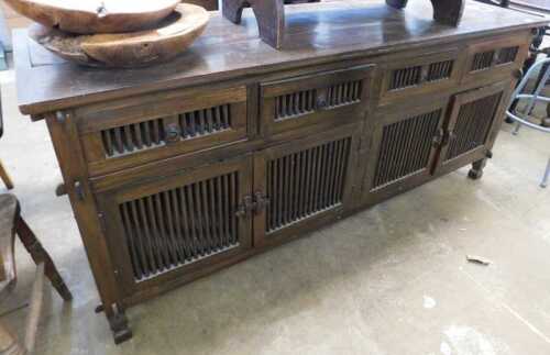 V - A Jig style hardwood side cabinet, of rectangular form, with pieced drawers above cupboard, on...