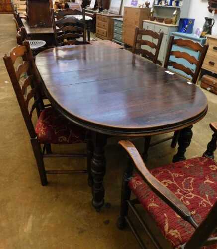 V - An early 20thC oak dining room suite, comprising D end extending table, and six (4+2) ladderback...