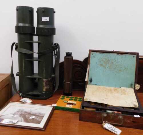 V - A military double explosives container, telescope, writing slope, Prinz movie reel, and a print,...