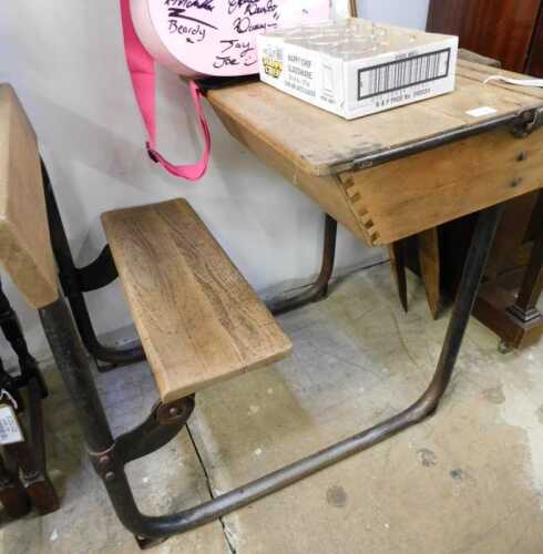 V - An early 20thC child's slatted wooden bench, with iron frame, 73cm high. NB. VAT is payable on...