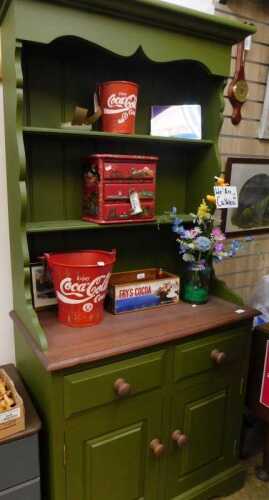 V - A kitchen dresser of small proportion, painted green, with open shelves above two drawers and...