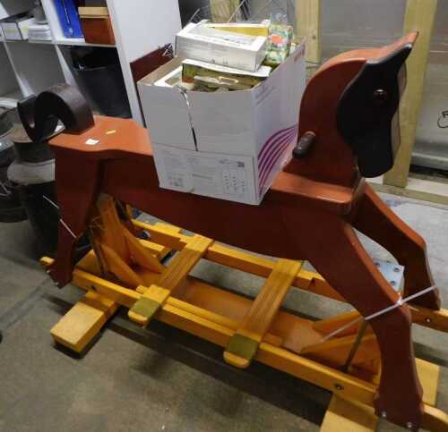V - A late 20thC rocking horse, partially painted brown, on an articulated base, 103cm high, and a...