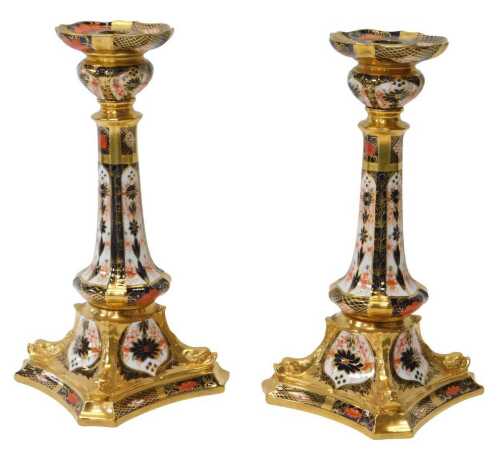 A pair of Royal Crown Derby porcelain candlesticks decorated in the Old Imari pattern, gold...