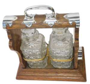 An early 20thC oak and silver mounted twin division tantalus, containing two cut glass square... - 2