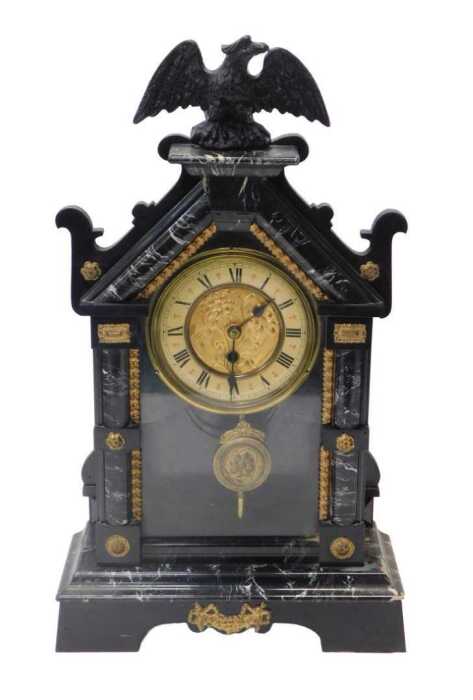 A late 19thC simulated marble ebonised mantel clock, the circular dial bearing Roman numerals,...