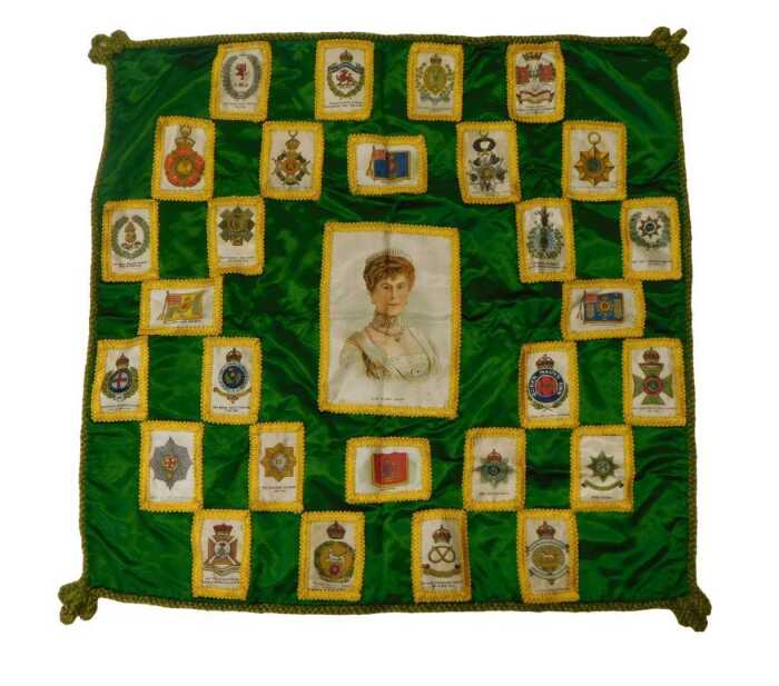 An early 20thC green silk cushion cover, decorated centrally with a silk depicting Her Majesty...