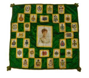 An early 20thC green silk cushion cover, decorated centrally with a silk depicting Her Majesty...