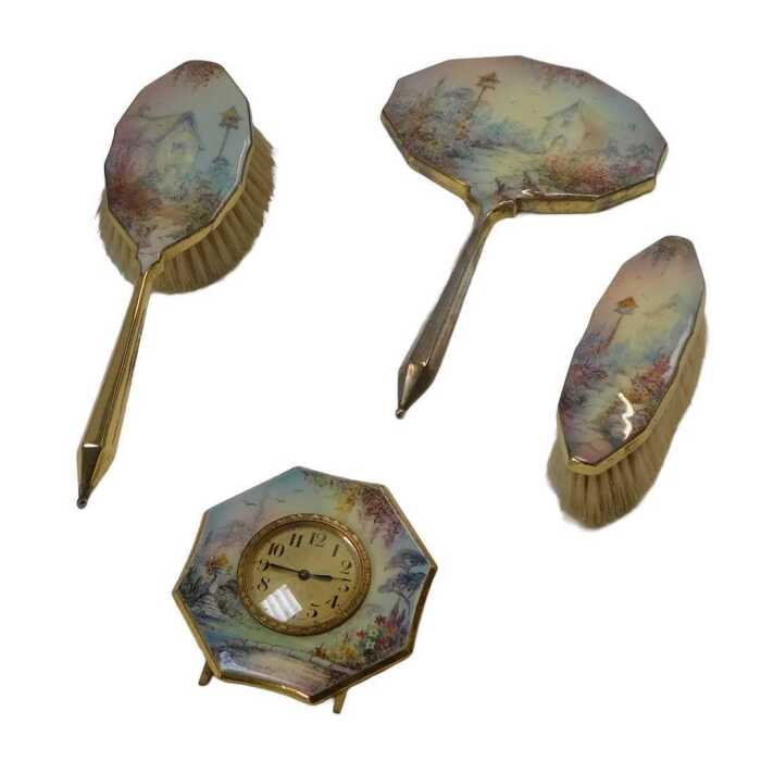 A mid 20thC hand painted enamelled dressing table set, comprising a hairbrush, hand mirror,...