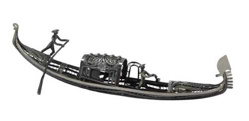 A white metal filigree model of a gondola, surmounted by two figures with paddles, white metal...