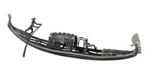 A white metal filigree model of a gondola, surmounted by two figures with paddles, white metal...