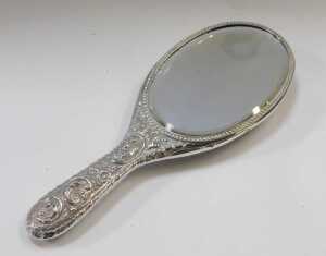 A Victorian silver backed hand mirror, embossed with flower head and scrolling motifs, with a... - 4