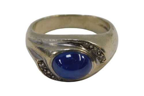 A sapphire and diamond dress ring, the centre set with a star set sapphire, 9.6mm x 5.2mm x...