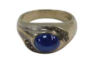 A sapphire and diamond dress ring, the centre set with a star set sapphire, 9.6mm x 5.2mm x...