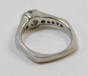 A sapphire and diamond dress ring, with a central round brilliant cut diamond, approx 0.76ct, in... - 2