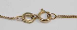 A 9ct gold pendant and chain, the pendant set with a square cut imitation diamond, with a swirl... - 3