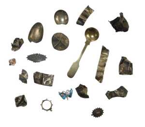 A group of white metal mounts, walking canes, cheroots, bottle tops, and an enamel butterfly...