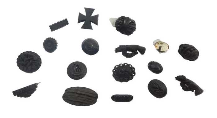 A group of jet and other memorial brooches, to include carved bird examples, a cross, vines, etc....