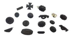 A group of jet and other memorial brooches, to include carved bird examples, a cross, vines, etc....