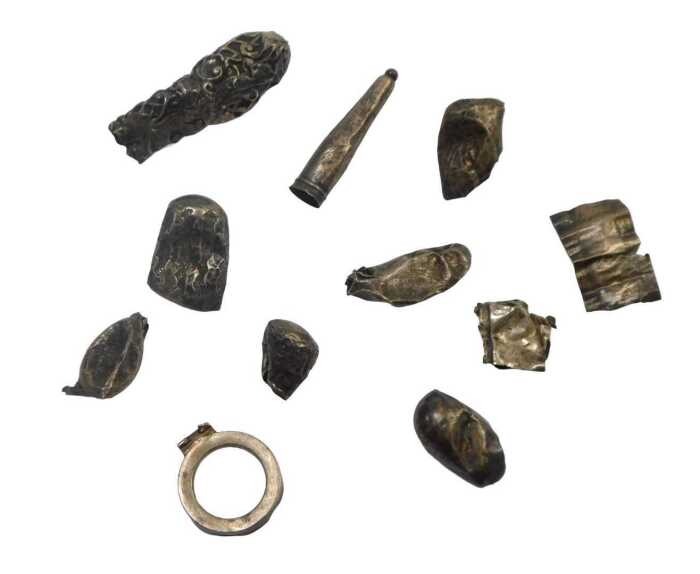 A group of white metal mounts, walking canes, cheroots, and bottle tops, 1.35oz. (AF)