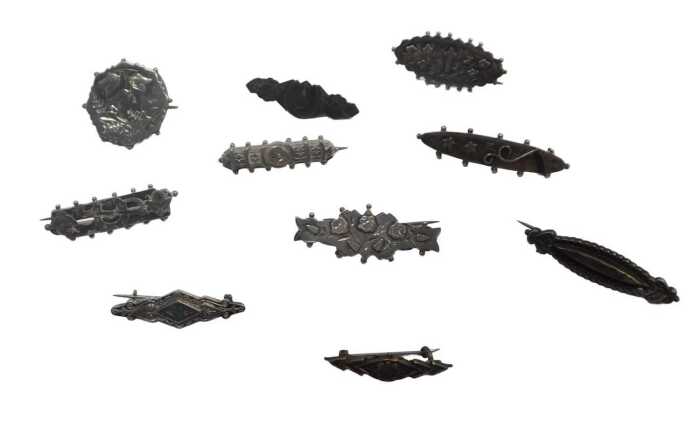 Ten silver Victorian and later sweetheart brooches, each of varying floral and horseshoe design,...