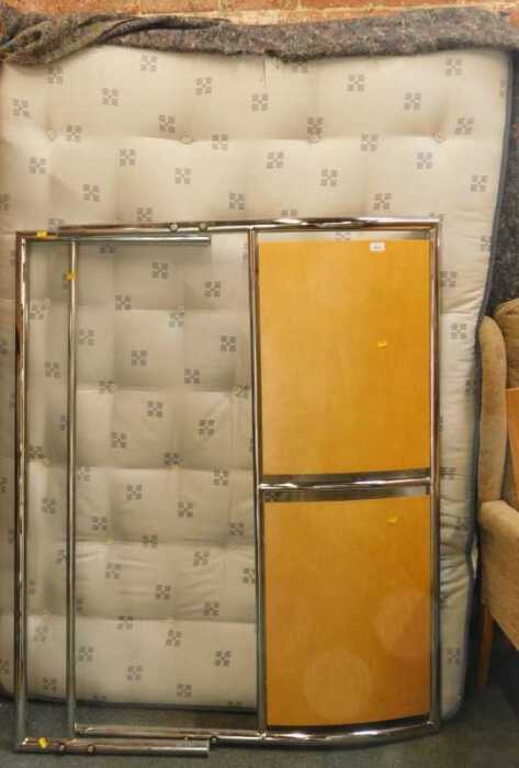 A double bed, comprising headboard, tailboard, mattress, and slatted wooden base.