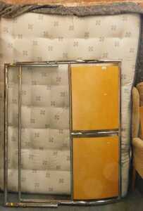 A double bed, comprising headboard, tailboard, mattress, and slatted wooden base.