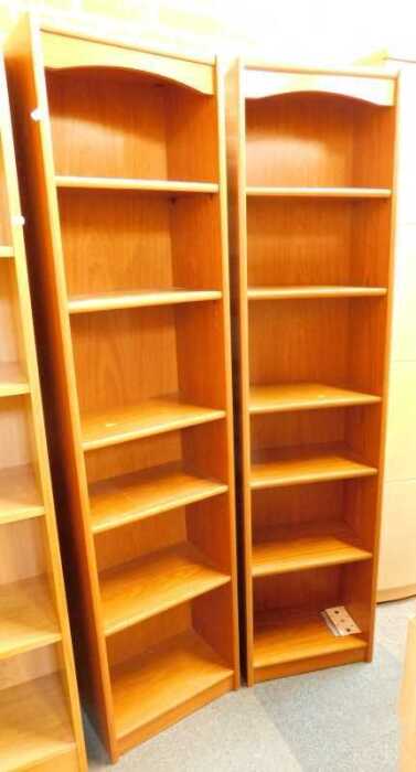 A pair of six shelf bookcases, finished in wood effect.