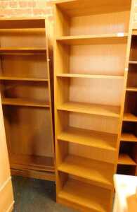 A pair of six shelf open bookcases.