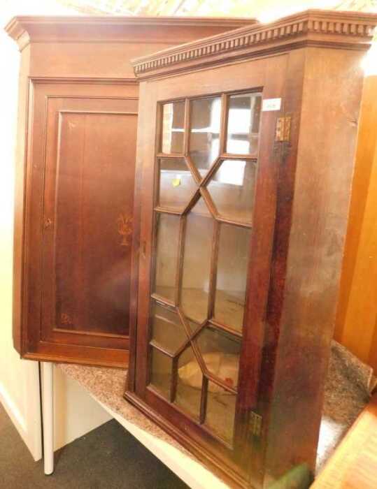A 19thC oak hanging corner cabinet, the top with a dentil moulded edge, above an astragal glazed...