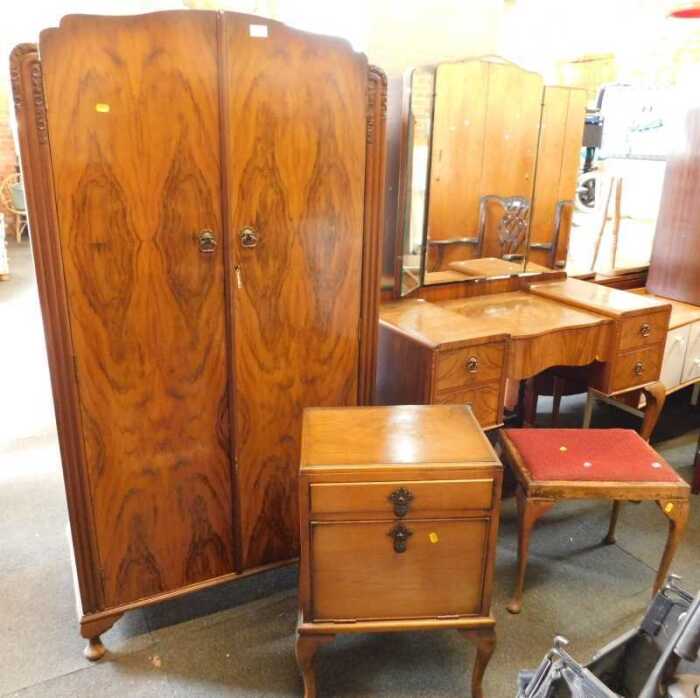 An early 20thC walnut veneered bedroom suite, consisting of a small two door wardrobe, doors...