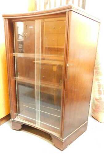 A bar with folding counter, with glass shelves to the interior.