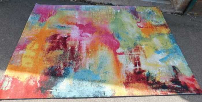 A Sunrise abstract multicoloured machine woven rug, 160cm x 230cm.