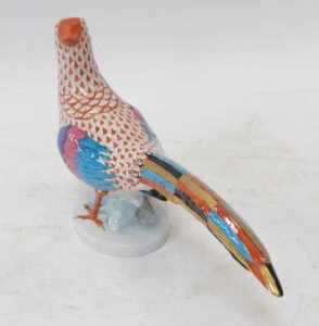 A Herend porcelain figure modelled as a pheasant, raised on an oval base, printed marks, 17cm high. - 2