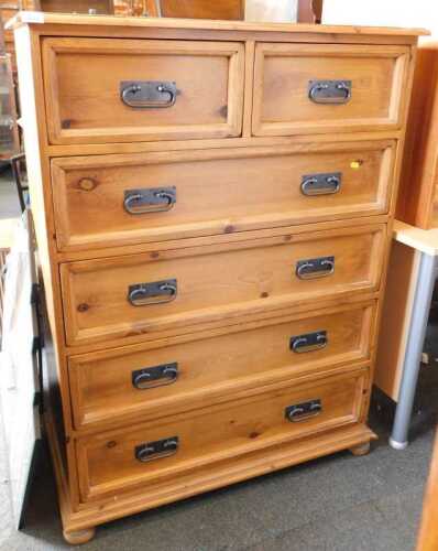 A contemporary pine chest, of two short over four long drawers, raised on short bun feet, 128cm...