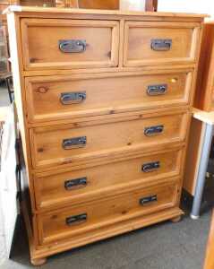 A contemporary pine chest, of two short over four long drawers, raised on short bun feet, 128cm...