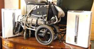 Two Mitsubishi dehumidifiers, model number MJ-E16VX, and a folding wheelchair by Karma, S-Ergo...