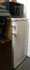 A Liebherr upright freezer, finished in white, and a Panasonic inverter oven. (2)