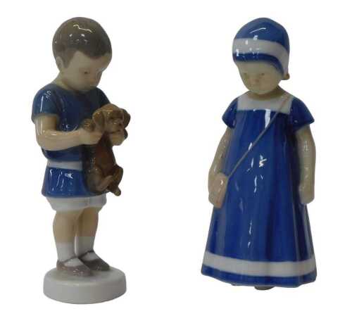 Two Bing & Grondahl porcelain figures, modelled as a boy holding a puppy, 17cm high, and a girl...