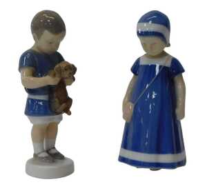 Two Bing & Grondahl porcelain figures, modelled as a boy holding a puppy, 17cm high, and a girl...