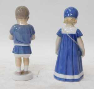 Two Bing & Grondahl porcelain figures, modelled as a boy holding a puppy, 17cm high, and a girl... - 2