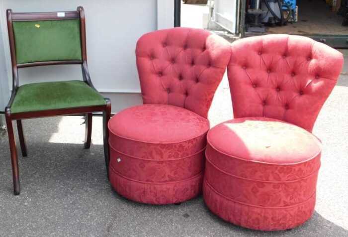 A pair of red upholstered tub nursing chairs, and a single dining chair, Regency style, raised...