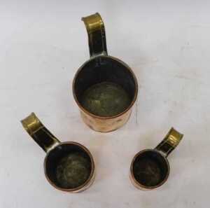 A set of three Victorian graduated copper and brass cream ladles, two pint, one pint, and half... - 2