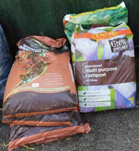 Four bags of decorative woodland bark, together with a bag of Professional Multipurpose compost,...