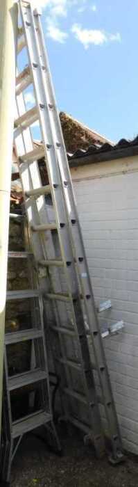 An extending steel ladder, together with a Trade ladder stand off.