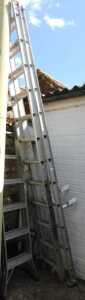 An extending steel ladder, together with a Trade ladder stand off.